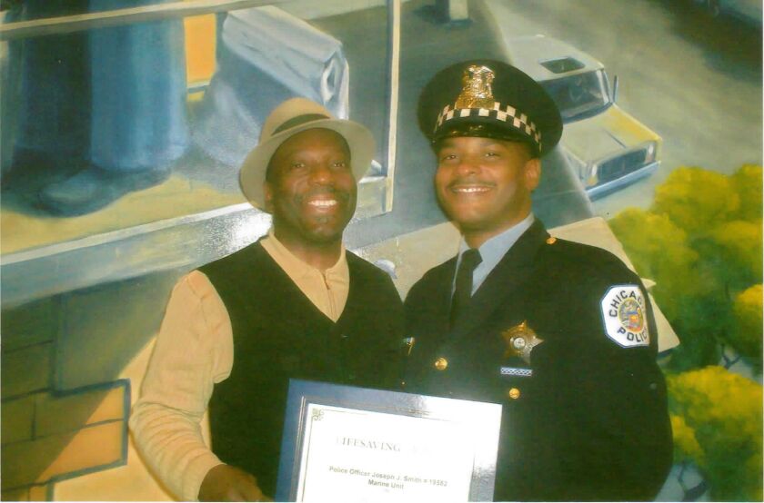 Officer Joseph Smith, right, with his father, James Smith, as the officer received the Chicago Police Department’s Lifesaving Award in 2010 at police headquarters.