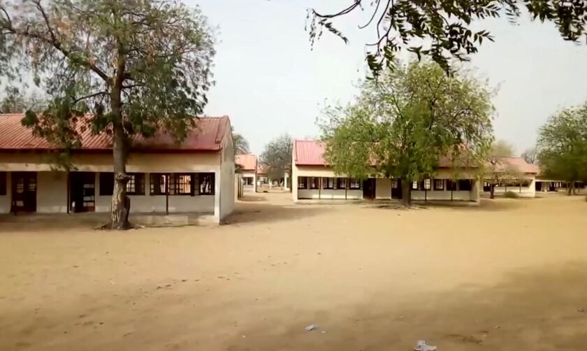 This image taken from video shows the exterior of Government Girls Science and Tech College in Dapchi, Yobe State, Nigeria on Thursday Feb. 22, 2018. Parents in northern Nigeria say more than 100 girls are still missing three days after suspected Boko Har