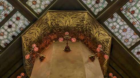 An ornate column capitals and an art glass ceiling