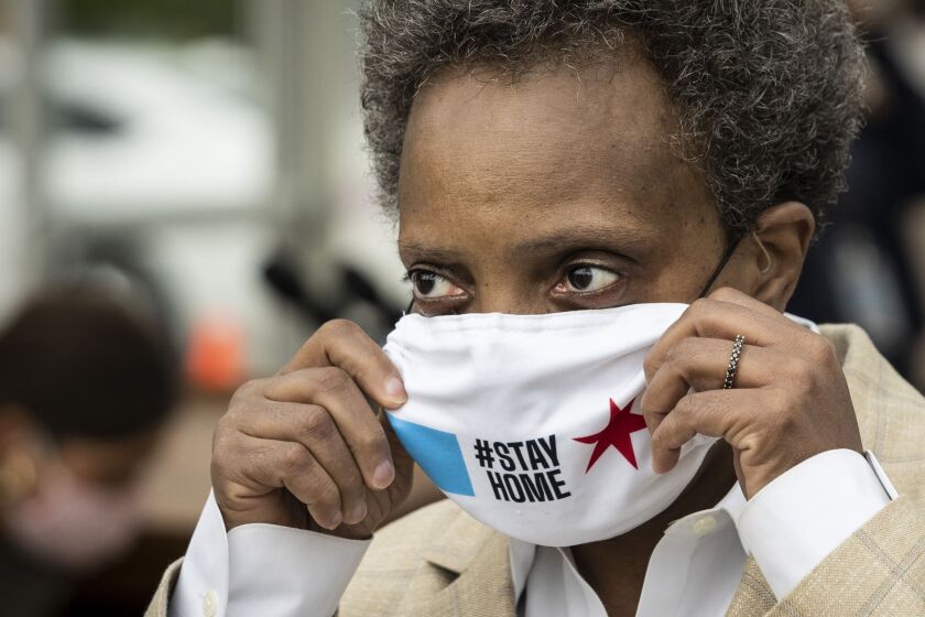 Mayor Lori Lightfoot wears a face mask as she tours a new coronavirus drive-thru testing site at Dr. Jorge Prieto Math and Science Academy, 2231 N. Central Ave. in Belmont Cragin, Monday morning, May 18, 2020.