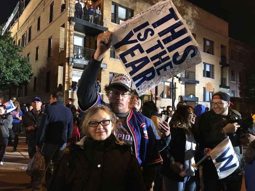 Shawn Zuydema celebrates with his daughter outside Wrigley Field on Saturday. “It feels great right now to see this happening.” | Jacob Wittich / Sun-Times
