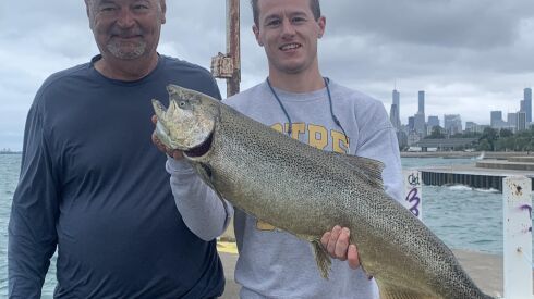 Jesse Granato (left) with a new friend, Jack (holding a Chinook he caught). Provided photo