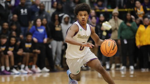 Waukegan's Carter Newsome (0) moves the ball during the sectional championship game against Warren.