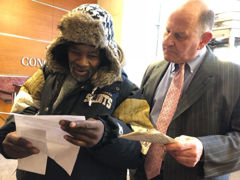 Woodrow Wilson Jr. (left) and his friend Nick Frisone read a letter that Kansas pawn shop owner Chris Mathis enclosed along with Wilson’s 37-year-old savings bonds. | Mitchell Armentrout/Sun-Times