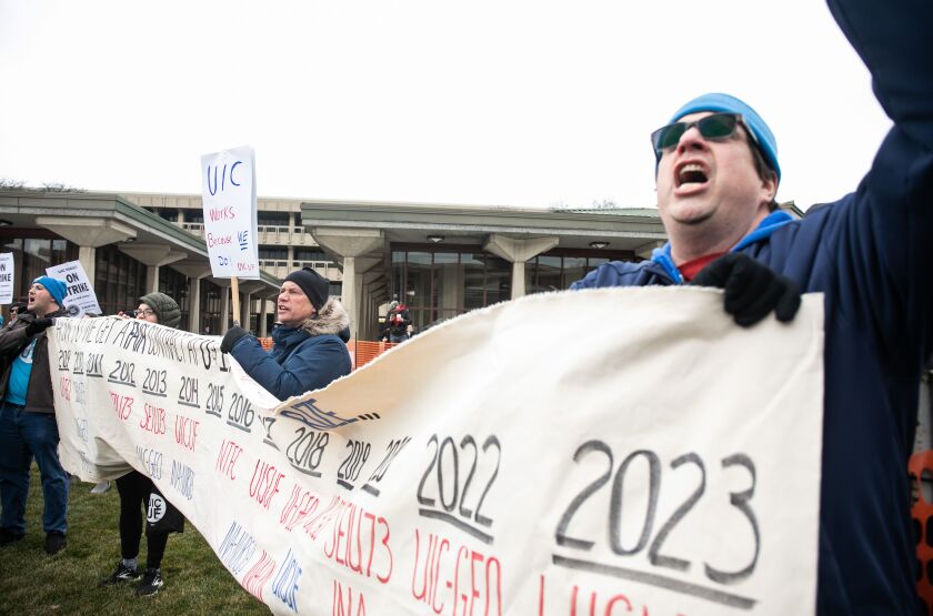 Faculty and their supporters chant during a strike at the University of Illinois Chicago in the Little Italy neighborhood, Tuesday, Jan. 17, 2023.