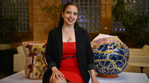 Art collector Sara Toussaint poses for a portrait alongside large ceramics during the Chicago Exhibition Week.
