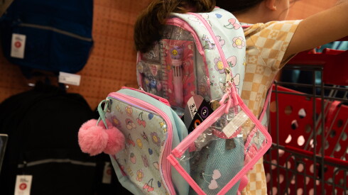A child wears a backpack inside a Target store.