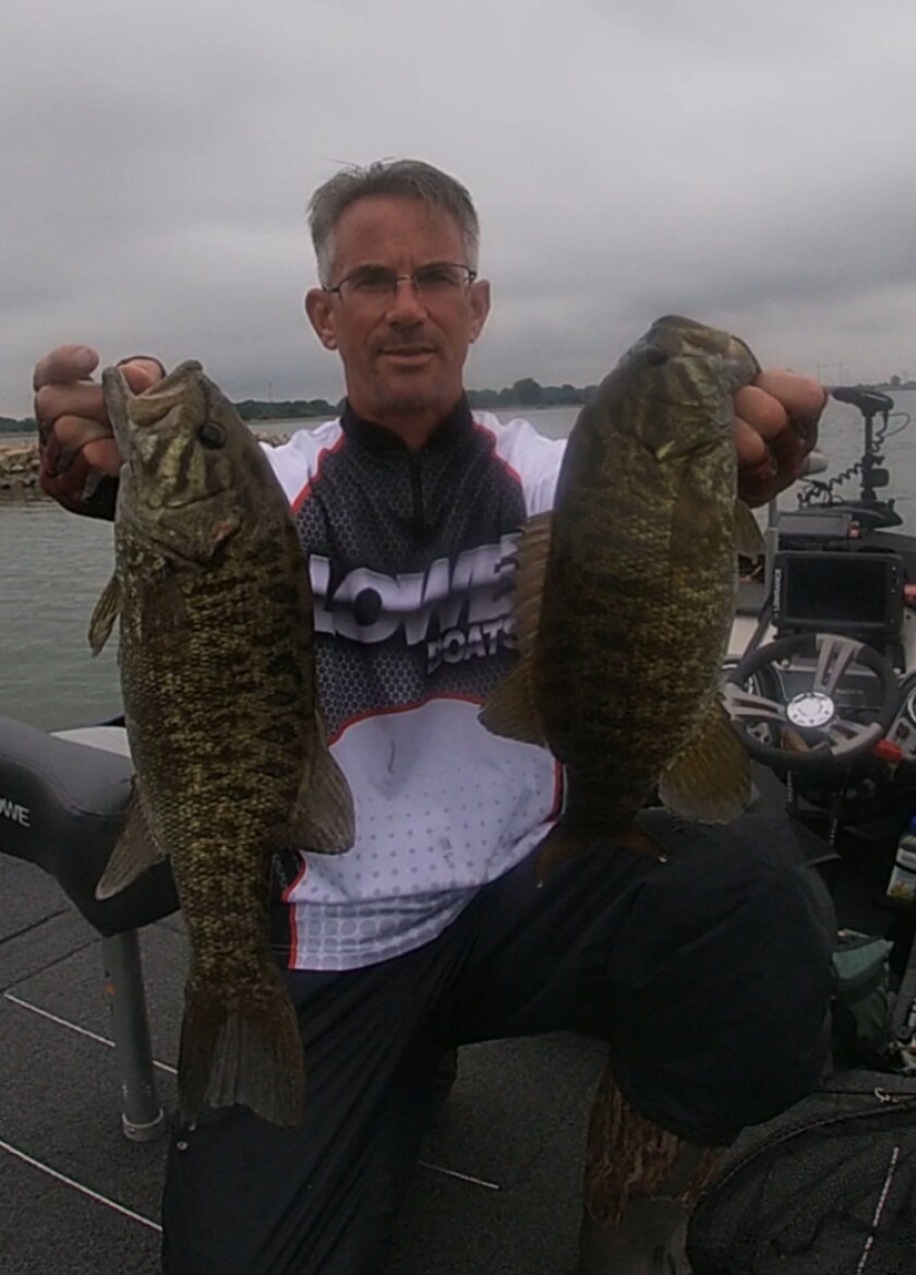Bob Johnson with a couple good smallmouth bass from Heidecke Lake. Provided photo