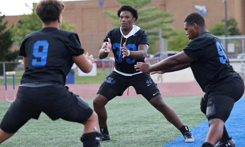 LINCOLN-WAY EAST'S JACOB ALEXANDER WORKS THROUGH A STRETCHING EXERCISE DURING PRACTICE.