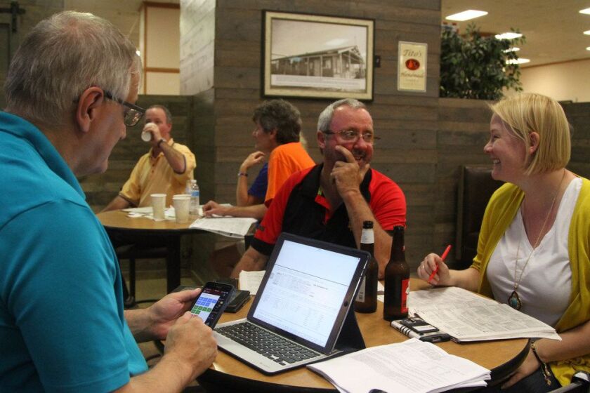 Chrissy Bialek, right, and Joe Karas work on handicapping the race day programs during opening day at Hawthorne Race Course. | Taylor Hartz/Sun-Times