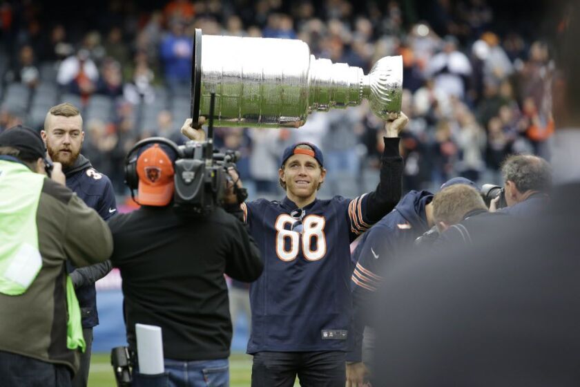 Patrick Kane holds up the Stanley Cup on Sunday at Soldier Field. (AP)
