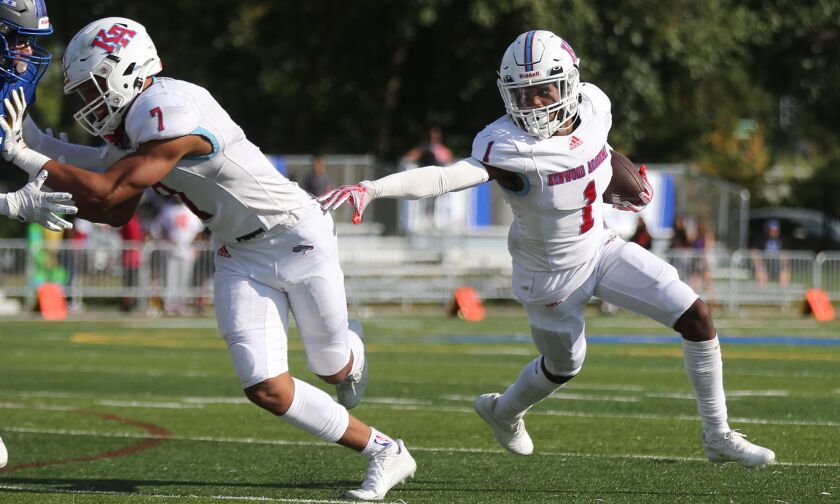 Kenwood’s Davonte Johnson (1) follows the block of Marquise Lightfoot (7) as the Broncos play Taft.