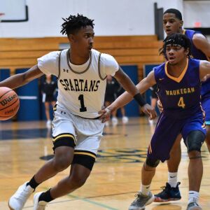 Marian Catholic’s Ahron Ulis (1) drives. Worsom Robinson/For the Sun-Times.