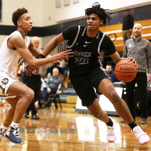 Fenwick’s Bryce Hopkins (23) dribbles around DePaul Prep’s Tyler Johnson (2).