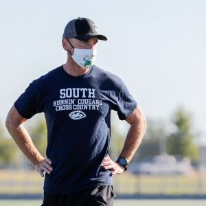 Plainfield South’s cross-country coach Jason Crowe looks on during practice.