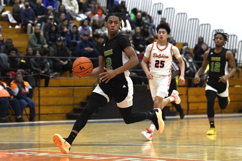 Westinghouse’s Damien Bolden (2) moves the ball past Young.