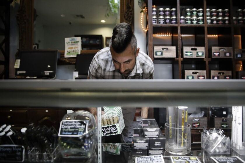 Stocking shelves with cannabis products at a Los Angeles store. | AP photo