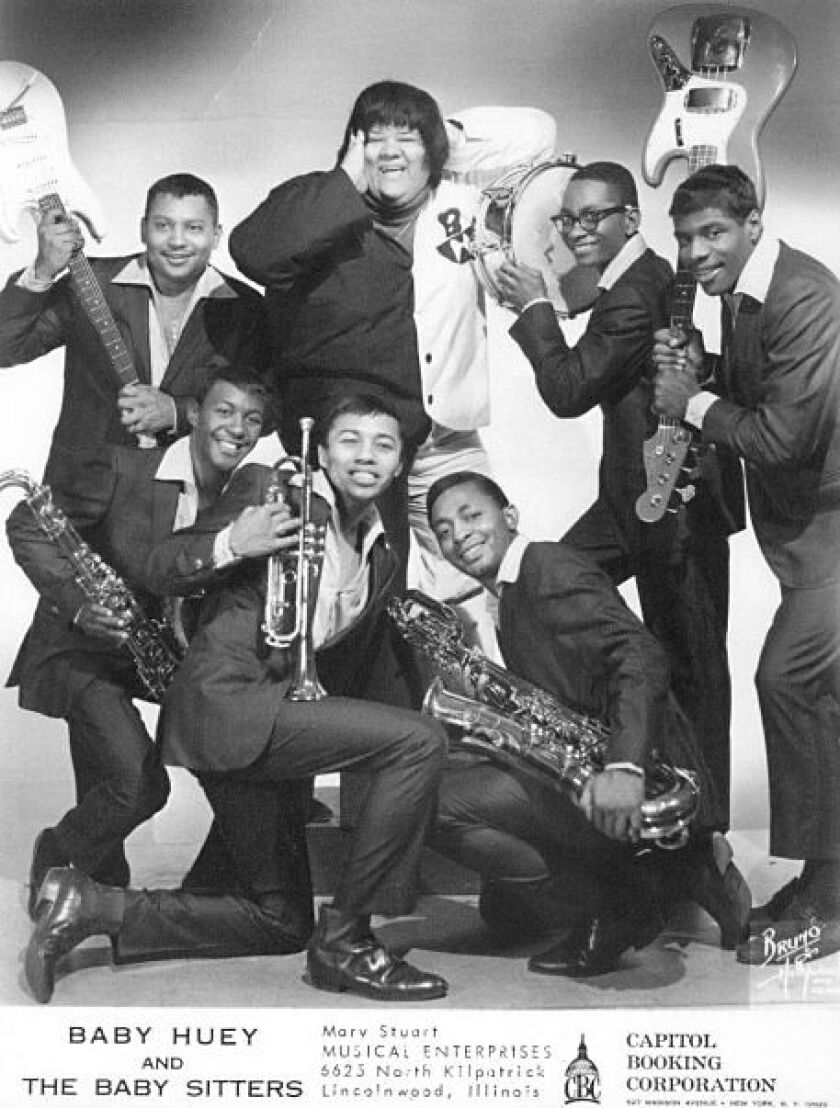 Melvyn “Deacon” Jones, kneeling in front with trumpet, and the rest of Baby Huey and the Babysitters.