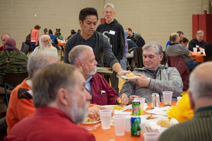 A volunteer serves lunch at the Center on Halsted’s annual Thanksgiving meal.