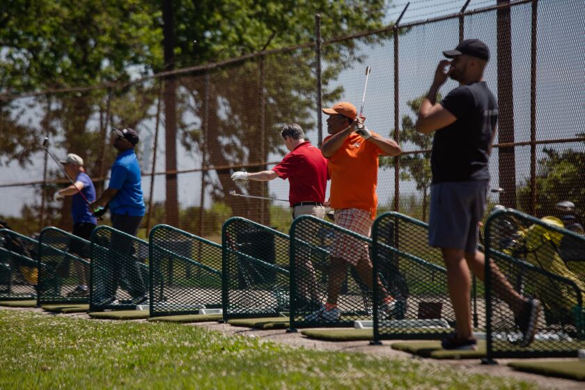 Ken Davis (center, in orange), 60, plays golf in Jackson Park, one of the parks that were re-opened on June 7, 2020 after Mayor Lori Lightfoot closed parks over COVID-19 safety concerns.
