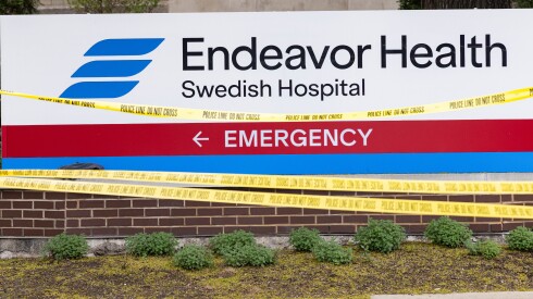 Police tape covers a sign at Swedish Hospital after the shooting on April 25.