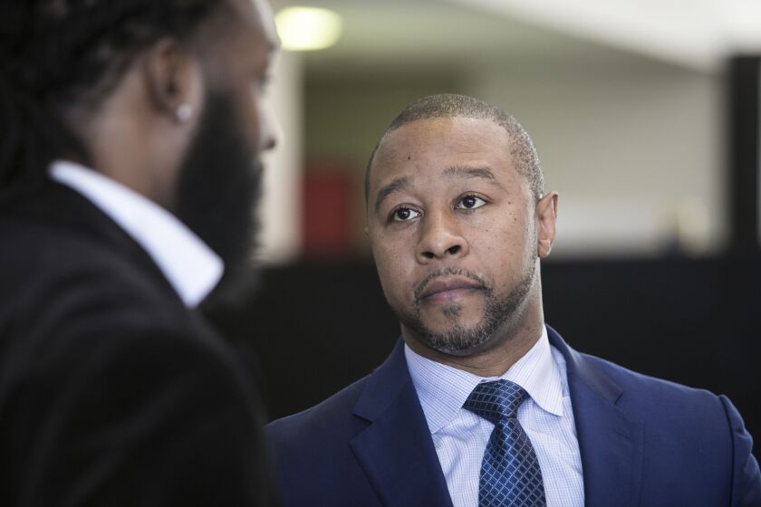 Attorney Jarrett Adams talks with a client at the Leighton Criminal Courthouse, Friday morning, March 9, 2018. | Ashlee Rezin/Sun-Times