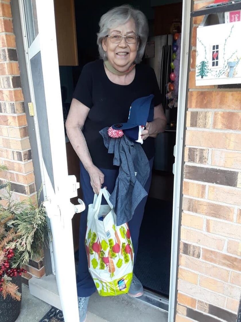 Roberta Kaminski, a senior citizen impacted by the coronavirus outbreak and its attendant stay-at-home order, receives a care package from the “Senior Relief Project” started by businessman Early Walker.