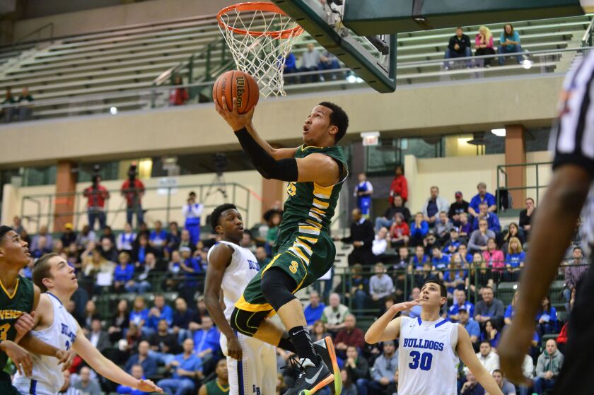 Stevenson’s Jalen Brunson (15) lays in a reverse shot against Riverside-Brookfield.