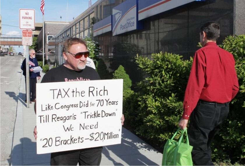 James Hodgkinson of Belleville protests outside of the U.S. Post Office in Downtown Belleville in 2012. | Derik Holtmann/Bellville News -Democrat