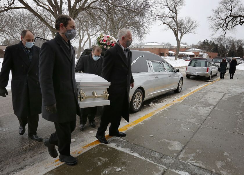 A casket for one of the Espinosa children killed in a house fire is carried into the Shrine of Our Lady of Guadalupe for a funeral Mass.