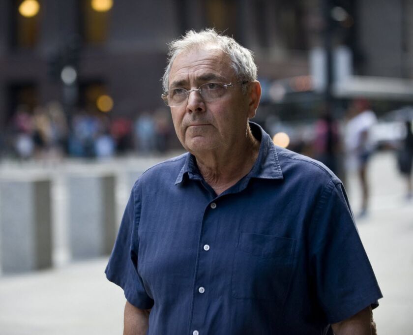 Aleksander Igolnikov of Northbrook, leaving the Dirksen Federal Building after his arrest, admitted being involved in the falsification of records so he could outfit 112 salvaged cars as cabs.