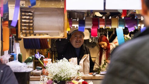 Baldemar Galindo, owner of Eventos Galindo Floral Design, helps a customer at his shop in Brighton Park.