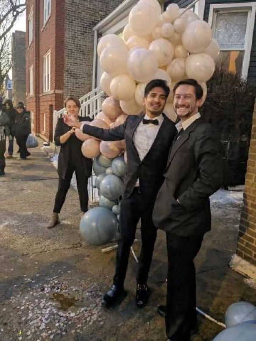 Raj Sarathy, a Roscoe Village resident, and his husband get married in front of the Chicago rat hole Saturday, Jan. 20, 2024.