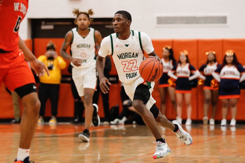 Morgan Park’s Marcus Watson Jr. (22) drives the ball past Young.