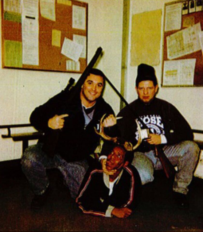 Former Chicago cops Jerome Finnigan and Tim McDermott pose with a black man identified by relatives as Michael Spann | (court file photo)