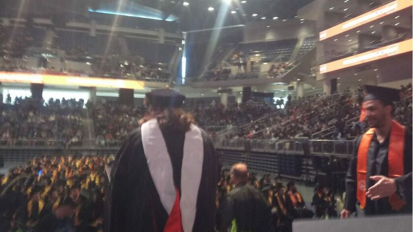 Harold Washington College teacher Kristin Bivens reads names at a graduation ceremony for students last year.