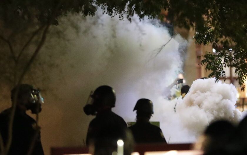 Smoke billows after Phoenix police used tear gas outside the Phoenix Convention Center. | Matt York/AP