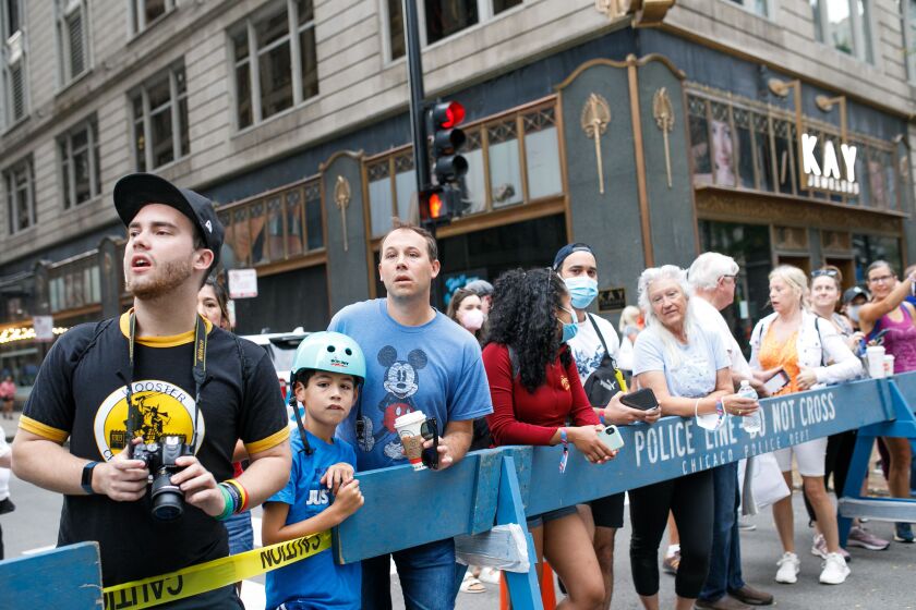 Spectators watch the Chicago Marathon along Jackson Boulevard on Sunday morning, Oct. 10, 2021.