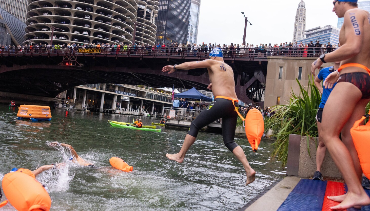 Two-mile swimmers jump in the water at the inaugural Chicago River Swim downtown Sunday, Sept. 21, 2025. | Candace Dane Chambers/Sun-Times.