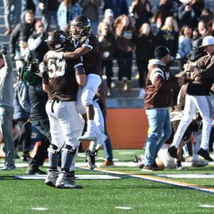 Joliet Catholic playesr storm the field. Worsom Robinson/For the Sun-Times.n/For Sun-Times