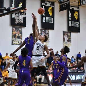 Waukegan’s Bryant Brown (25) hits Marian Catholic’s Ahron Ulis (1). Worsom Robinson/For the Sun-Times.
