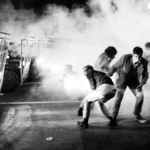 Soldiers using tear gas and barbed wire strung on jeeps to push protesters up Michigan Avenue. | Sun-Times files