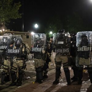 Police use tear gas on protesters as they clash outside the Kenosha County Courthouse in the second night of unrest after police shot Jacob Blake, Monday night, Aug. 24, 2020.