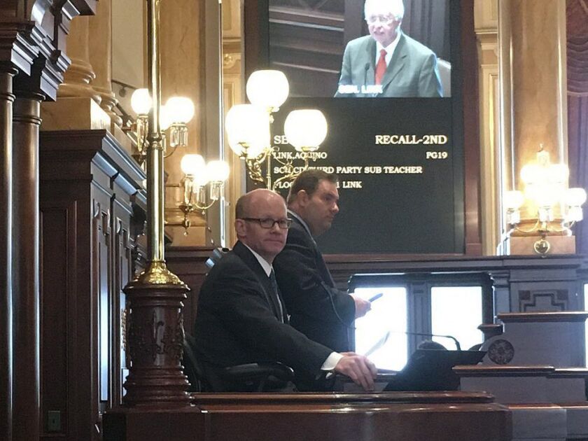 President Pro Tempore of the Senate Don Harmon, a Democrat from Oak Park, seated, presides over the Illinois Senate Wednesday, next to Senate Parliamentaran Giovanni Randazzo. Harmon is sponsor of legislation to require state licensing of firearms dealers