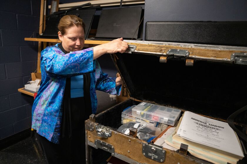 Chicago Symphony Orchestra’s librarian Carole Keller shows a trunk that stores librarians’ supplies and musicians’ parts backstage at Symphony Center.