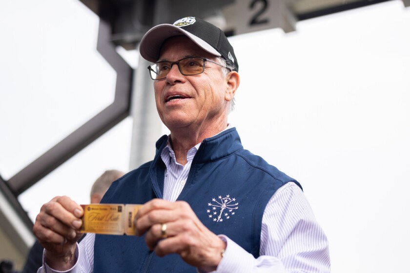 Indiana Gov. Mike Braun holds a ceremonial golden ticket before boarding the first South Shore Line train ride along the Monon Corridor in Hammond. | Candace Dane Chambers/Sun-Times