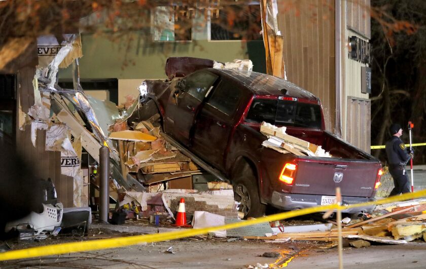Personnel work at the scene in McHenry, Ill. where a vehicle drove into the Starbucks Thursday, Jan. 16, 2020. (