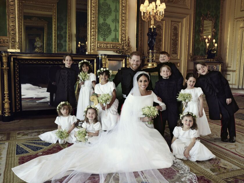 In this photo released by Kensington Palace on Monday May 21, 2018, shows an official wedding photo of Britain’s Prince Harry and Meghan Markle, center, in Windsor Castle, Windsor, England, Saturday May 19, 2018. Others in photo from left, back row, Brian
