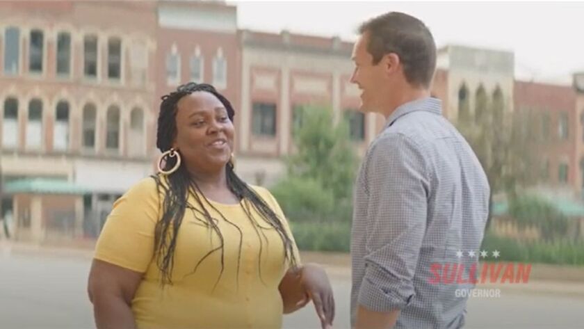 Republican Jesse Sullivan talks with a potential voter in a scene from his campaign commercial.