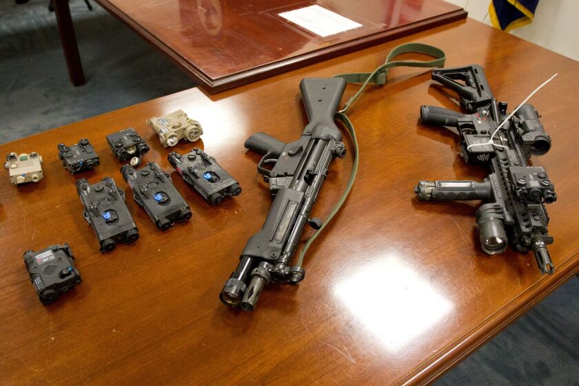 Laser gun sights (left) that were seized in an investigation leading to federal gun-trafficking convictions against three Lake County, Indiana, sheriff’s officers in 2011.